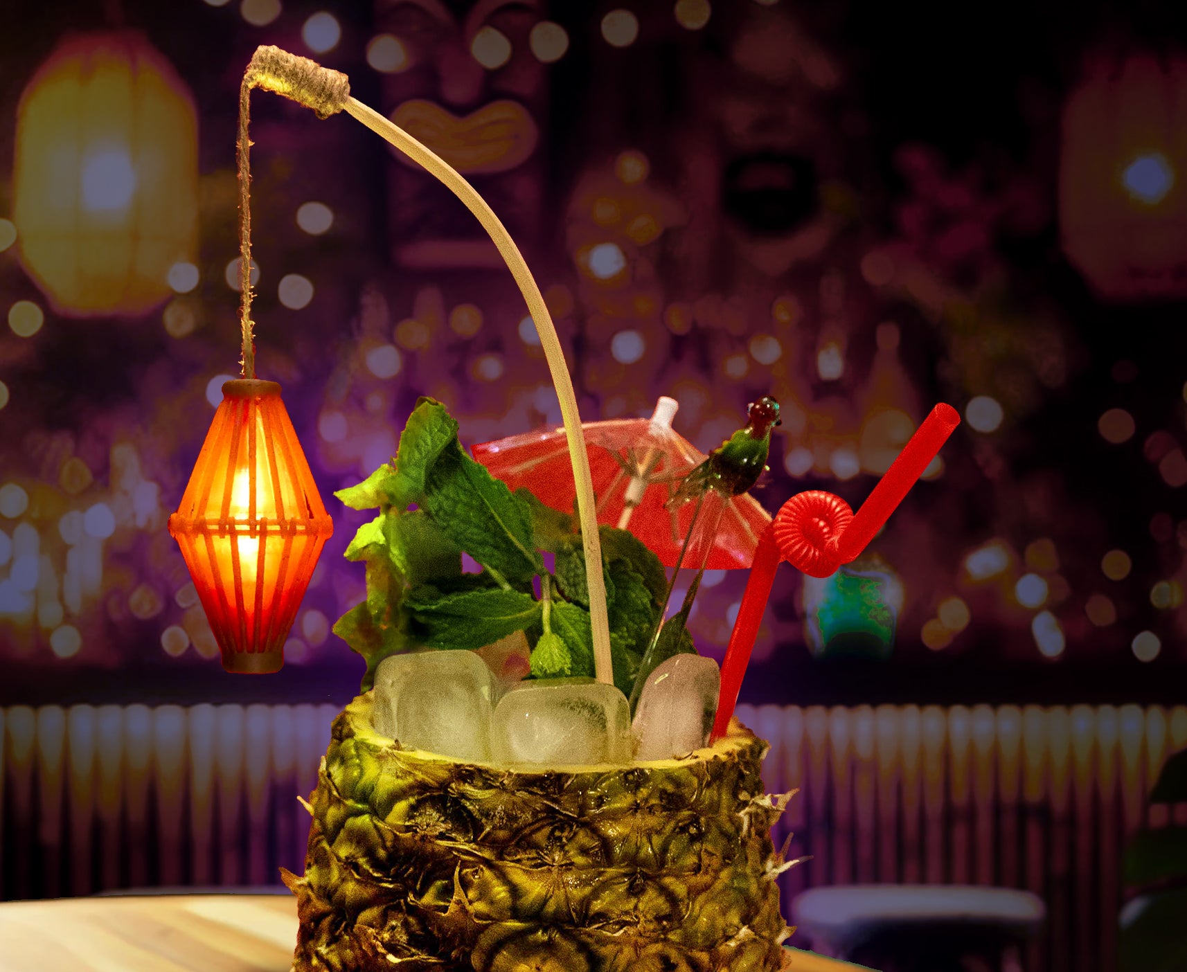 Tiki drink with illuminated bamboo cage lamp swizzle stick